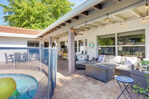 A covered outdoor patio with seating, a pool, and a view of the surrounding area. - Pool Oasis & Fenced Yard: Central Wellington Home (Wellington)