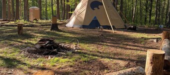 Sleep under the trees in a Native American Tipi - off-grid glamping experience!