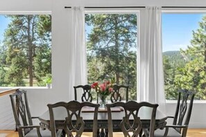 Bright dining nook framed by evergreens and natural light - Near Red Rocks w/ Hot Tub, Fire Pit & Views (Indian Hills)
