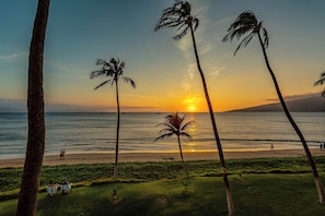 A sunset view with palm trees, a beach, and a golf course. - Sugar Beach Resort, #235 1 Bedroom Condo by RedAwning (Kihei)