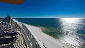 A balcony with a view of a beach and ocean. - Phoenix Gulf Towers 2408 4 Bedroom Condo (Orange Beach)