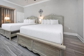 A double bed with a headboard, a bedside table, a lamp, and a wall-mounted light fixture. - Phoenix Gulf Towers 2606 2 Bedroom Condo (Orange Beach)