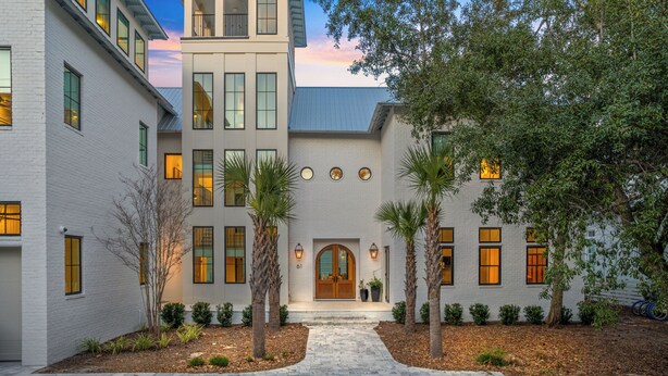 A modern building with a central entrance, multiple windows, and a brick facade. - Luxury Seagrove w Pool, Hot Tub, Golf Cart & Bikes, Elevator (Seagrove Beach)
