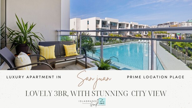 A luxury apartment with a balcony, a pool, and a city view. - Stunning New 3/2 Condo, near Beach & SJ Airport. 2 Pools, WiFi, AC  (Carolina)