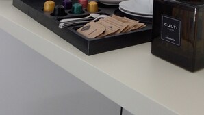 A hotel room's minibar with a coffee maker, tea bags, and a candle holder. - OBLO' PORTOVENERE GUESTHOUSE (Portovenere)
