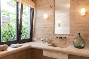 A bathroom with a large window, a sink, two pitchers, a green vase, and a mirror. - Granite house, right on the water, Malmousque (Marseille)