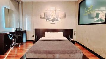 A modern bedroom with a large bed, a desk with a chair, and a large screen displaying 'Lott Residence'.