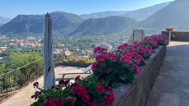 A balcony with a view of mountains and a town below. - Charming Location Between Positano and Sorrento (Piano di Sorrento)