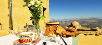 Noble palace with a sky view in the mountains, near the historic center of Erice