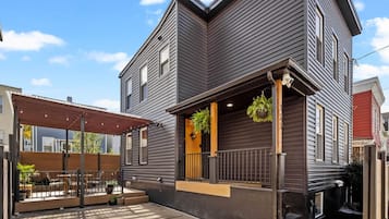 A two-story building with a covered patio area.