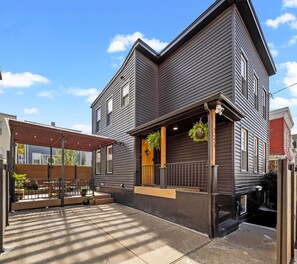 A two-story building with a covered patio area.