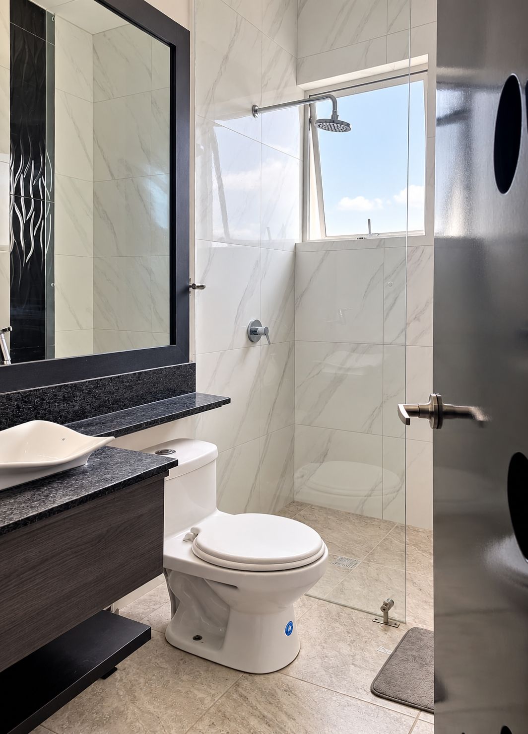 A modern bathroom with a toilet, sink, and shower.