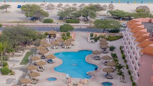 A resort with multiple swimming pools, beach access, and a view of the ocean. - Paradise Beach Villas (Oranjestad)