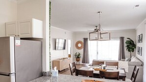 A modern kitchen with white cabinets, a granite countertop, and a stainless steel refrigerator. - Amazing vacation rental, great location,pool,close to the beach and golf course  (Myrtle Beach)