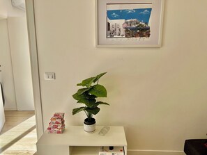 Simple, functional space with a console table, potted plant, and storage.