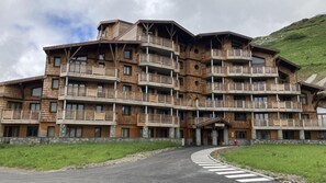 A multi-story wooden building with balconies, a stone base, and a sign reading "ARIETIS." - 10m from ski slopes, Ground floor, balcony, tv, ski locker, 62m², Avoriaz (Avoriaz)