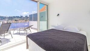 A balcony with a bed, a chair, and a table. - Superb  Rooftop Roquebrune Parking (Roquebrune-Cap-Martin)