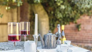 Enjoy a peaceful afternoon tea in a serene outdoor setting with a beautifully set table.