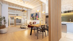 A modern interior with a dining area, kitchen, and a staircase leading to an upper level. - Genteel Home Santas Patronas V (Seville)