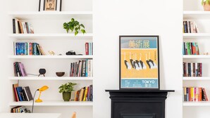 A room with a fireplace, white shelves with books, a desk, and a chair. - Cosy 1Bed Flat, Leamington Spa - Pass the Keys (Leamington Spa)