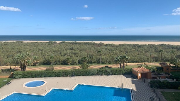 A pool area with a view of the beach and ocean. - Los Pelicanos 101 - Two Bedroom Apartment, Sleeps 5 (Punta del moral)