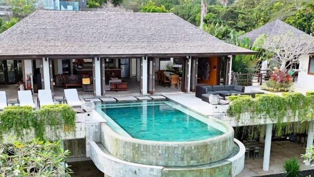 A poolside area with a covered seating area, a pool, and lush greenery. - Villa Cantik Pandawa By Fays Hospitality (Bali)