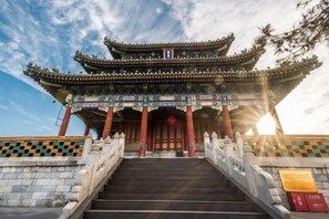 A traditional multi-tiered building with a staircase leading to the entrance. - Jinjiang Inn Select (Wenzhou High-speed Railway Station Xinqiao) (Wenzhou)