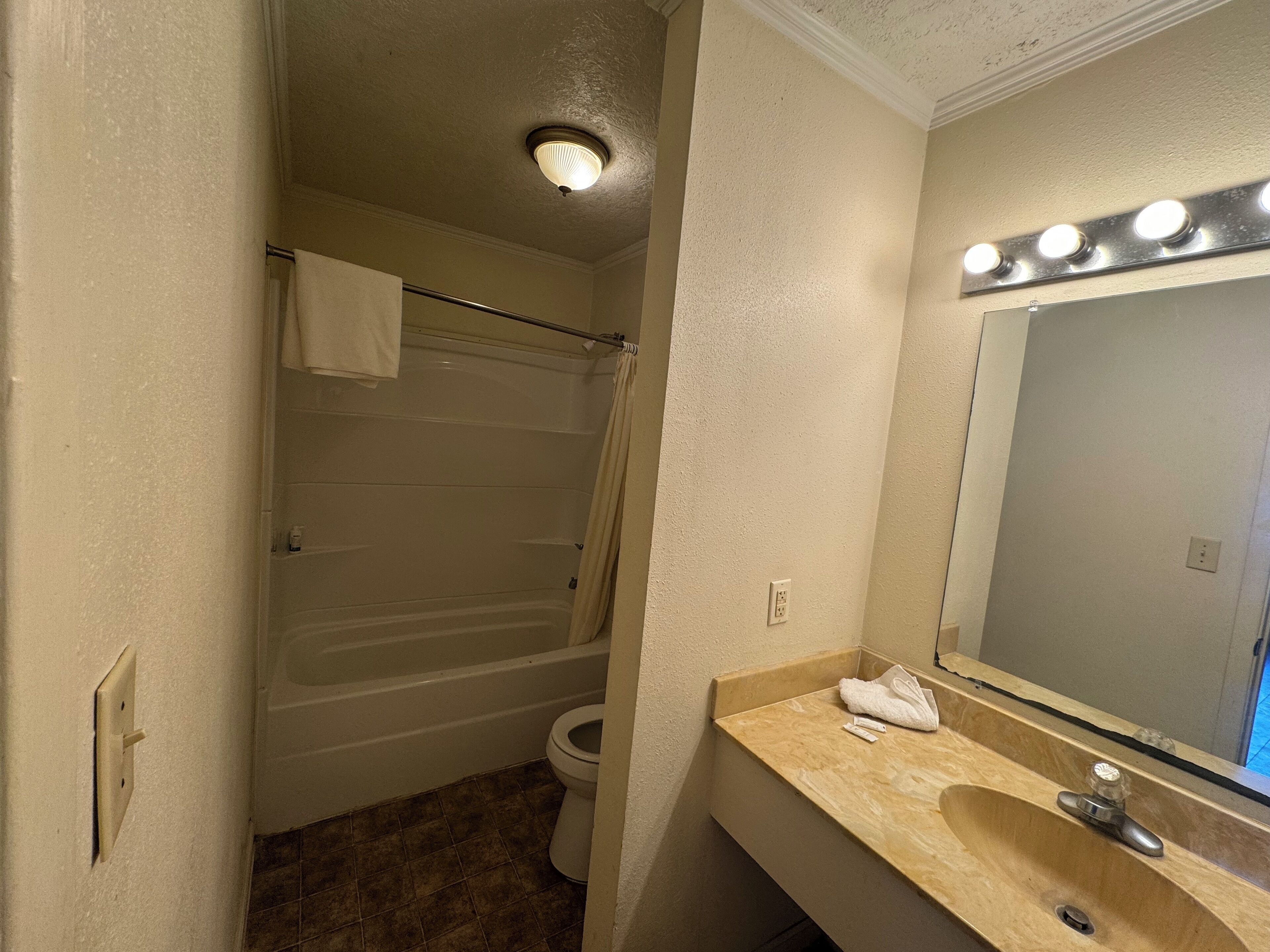 A bathroom with a bathtub, toilet, and sink.
