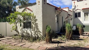 A house with a stucco exterior, a red-tiled roof, and a small front porch with steps. - Waterfront Gulfport Studio w/Shared Private Beach + Walk to Beach & Dining (Gulfport)