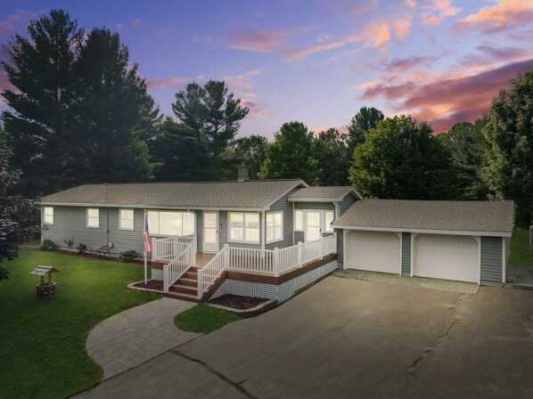 A two-story house with a front porch and a garage.