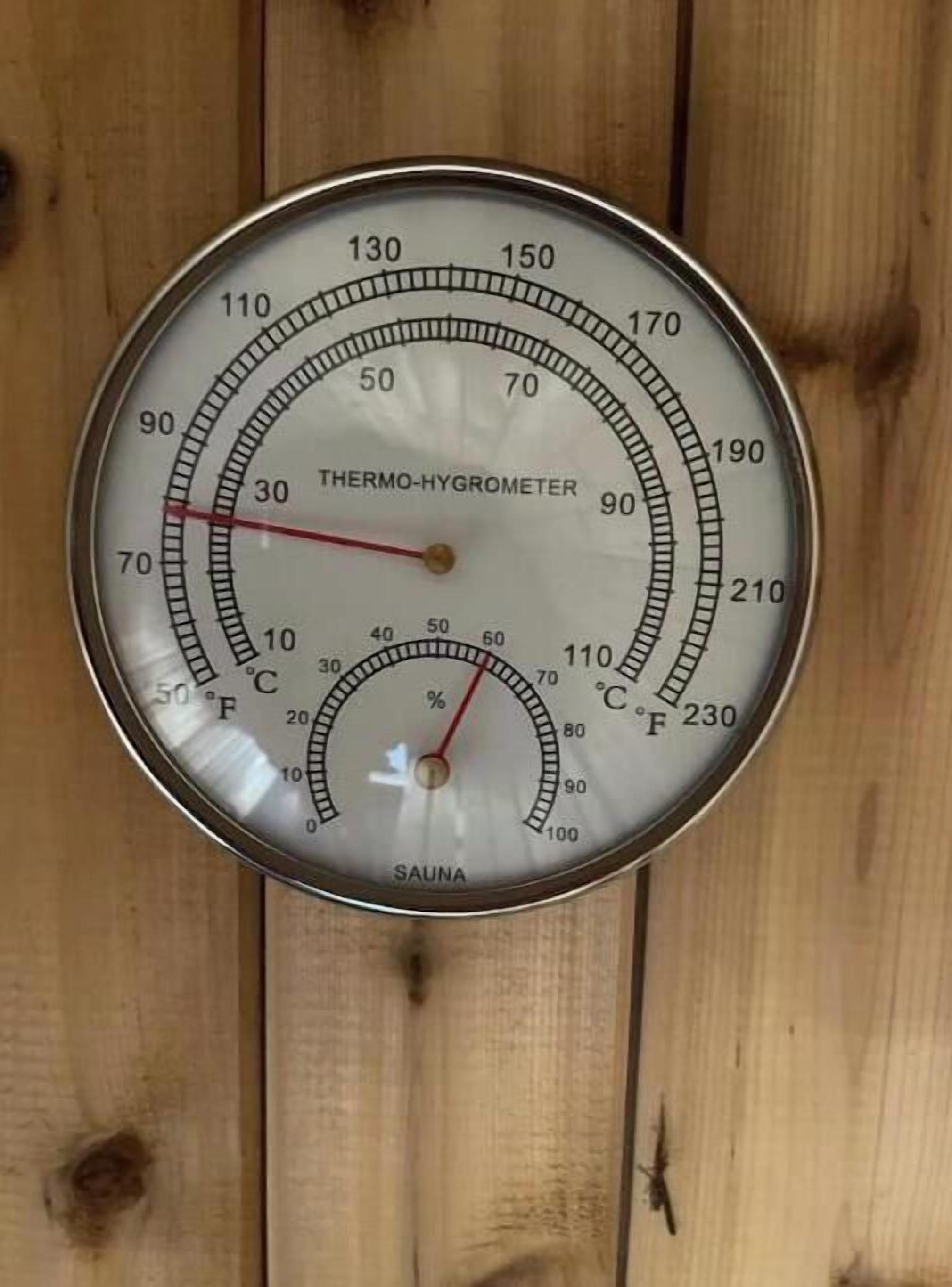 Un thermomètre-hygromètre fixé à un mur en bois.