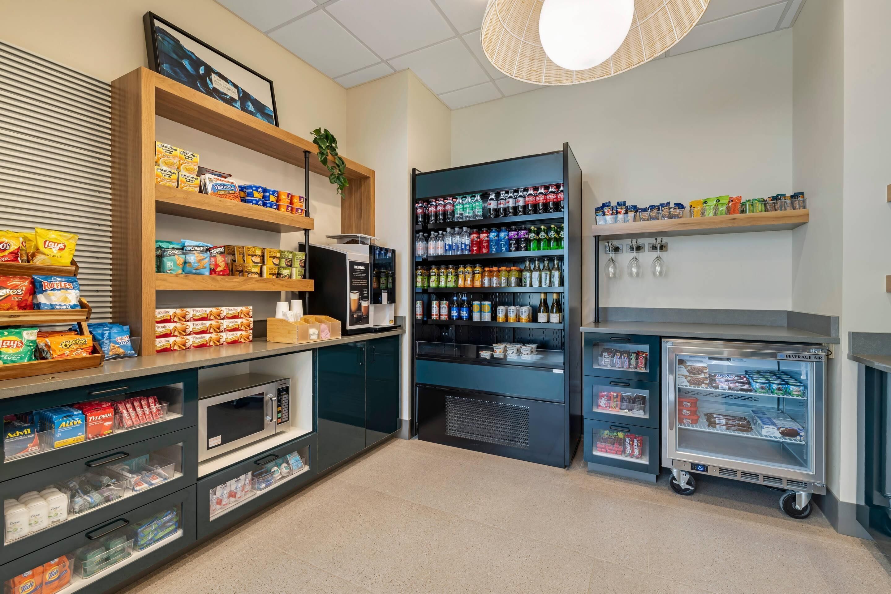 A self-service kiosk with shelves stocked with snacks, beverages, and condiments.