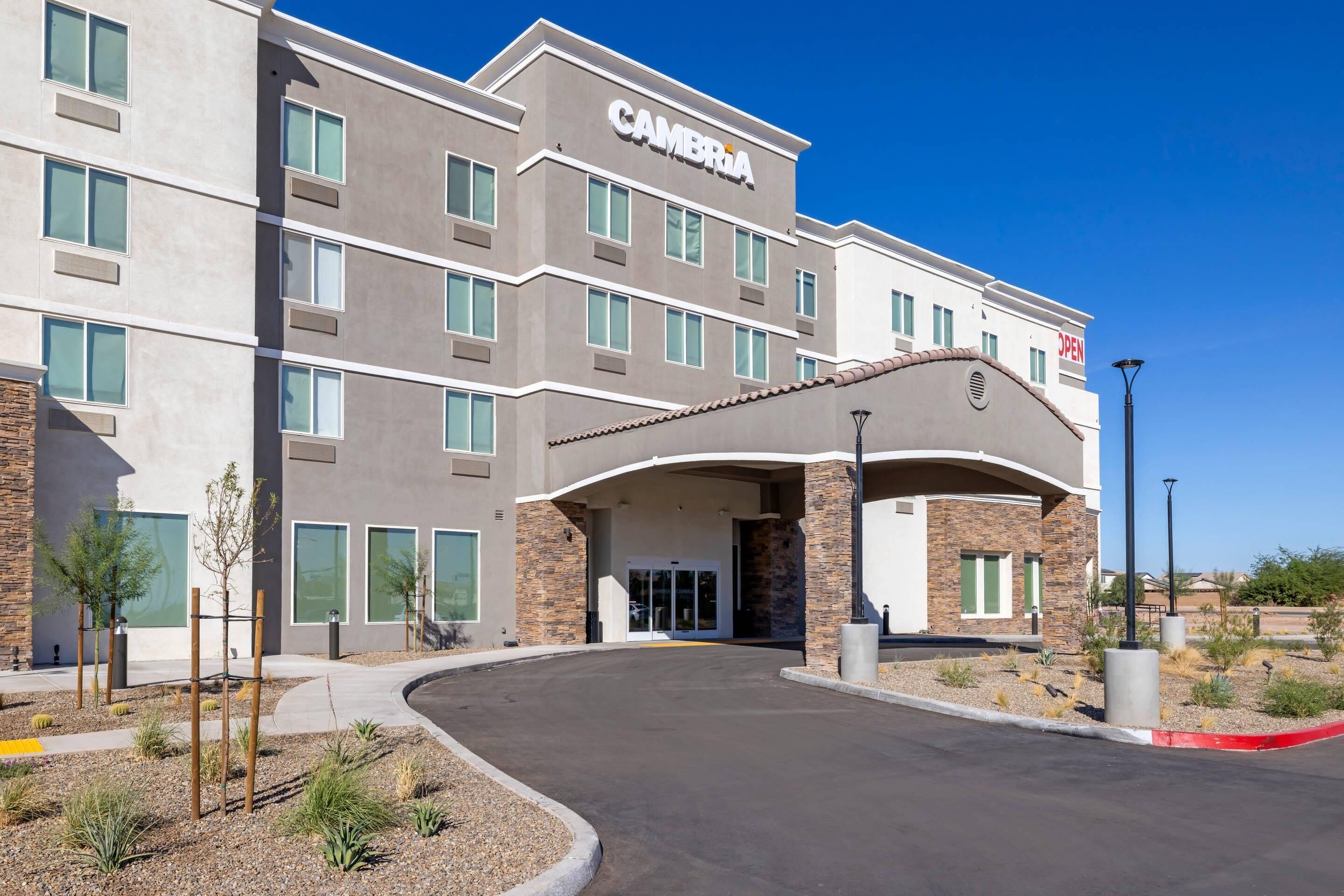 A modern hotel with a flat roof, large windows, and a welcoming entrance.