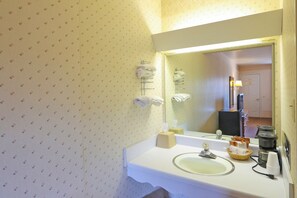 A bathroom with a sink, mirror, towel rack, and toiletries. - Hotel O Relax Inn Lewisburg near I-64 (Lewisburg)