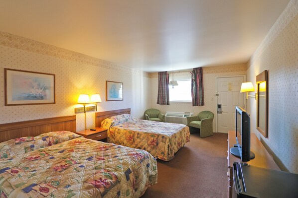 A hotel room with two beds, a desk with a computer, a TV, and a window with curtains. - Hotel O Relax Inn Lewisburg near I-64 (Lewisburg)