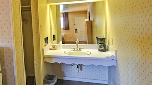 A bathroom with a sink, mirror, and a coffee maker on the counter. - Hotel O Relax Inn Lewisburg near I-64 (Lewisburg)