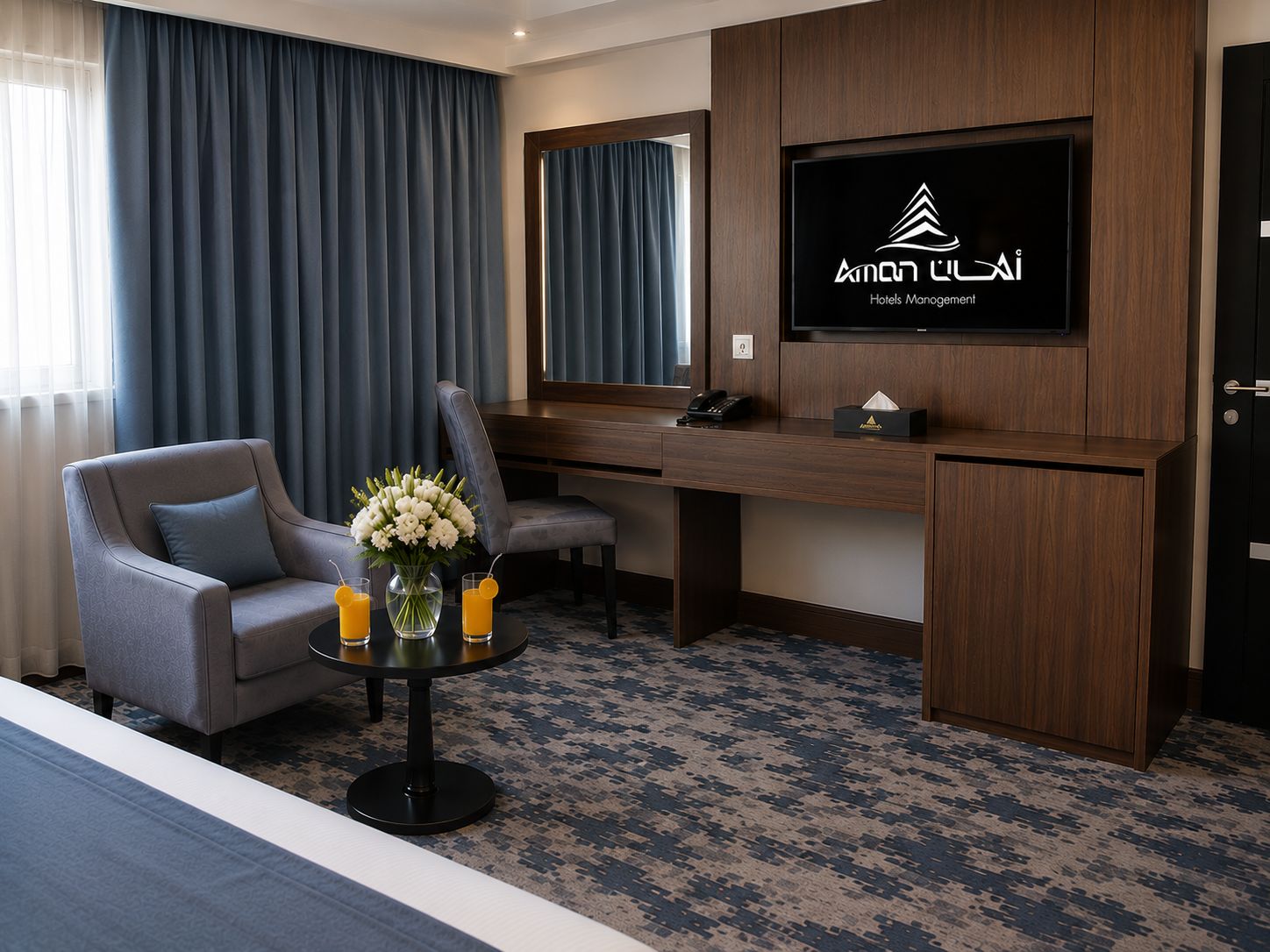 A hotel room with a bed, a desk, a chair, a TV, and a vase with flowers.