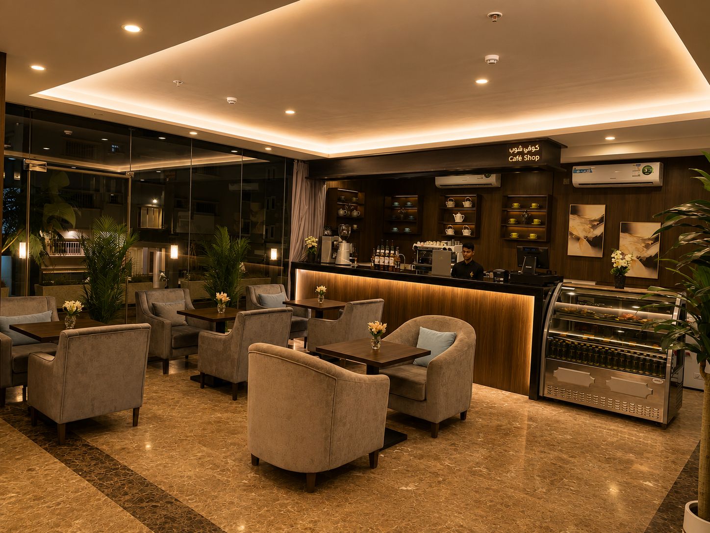 Un interior moderno con una zona de bar, asientos y vistas a través de amplios ventanales.