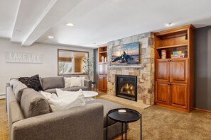 TV, fireplace, books, offices - Lakefront Getaway: Sauna, Hot Tub, Firepit & More! by RedAwning (Shoreview)