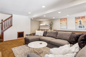 TV, fireplace, books, offices - Lakefront Getaway: Sauna, Hot Tub, Firepit & More! by RedAwning (Shoreview)