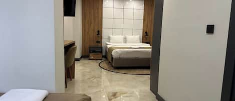 Deluxe Triple Room, City View | In-room safe, individually decorated, individually furnished, desk