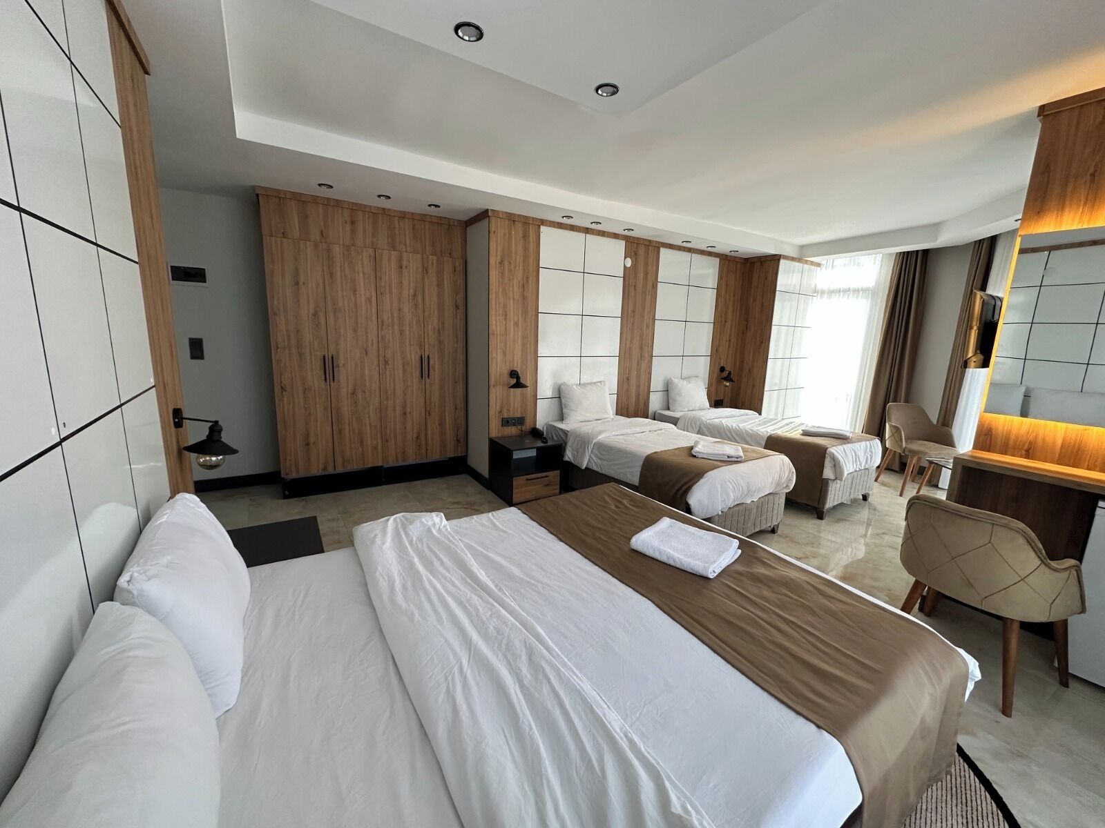 Deluxe Quadruple Room, City View | In-room safe, individually decorated, individually furnished, desk