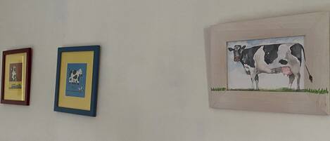Three framed artworks on a wall.