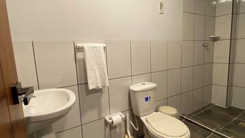 A bathroom with a sink, toilet, and shower.
