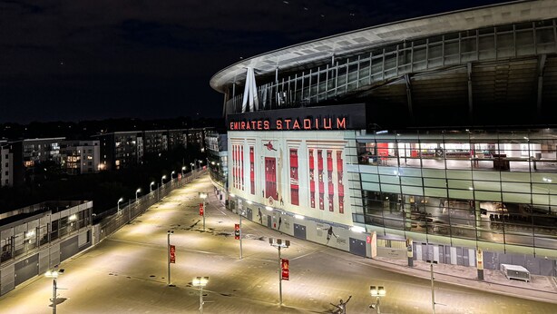 Emirates Stadium with a large, modern structure and a prominent sign.