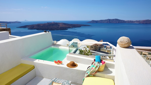 Una terraza en la azotea con piscina, zonas de estar y vistas al mar y a las islas.