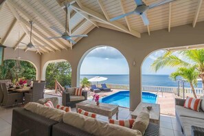 A covered outdoor area with a pool, seating, and a view of the ocean. - Villa Trupial is a family home with a view of the Caribbean Sea (Cas abao)