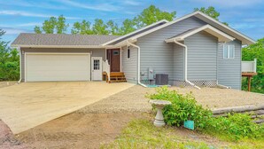 A single-story house with a garage, a front porch, and a small deck. - Family-Friendly ‘Lakeview Cottage’ w/ Deck & View (Yankton)