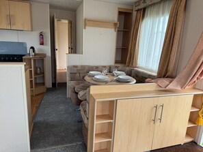 Cozy living space with a kitchenette, dining area, and seating area, offering ample storage and a safe environment.