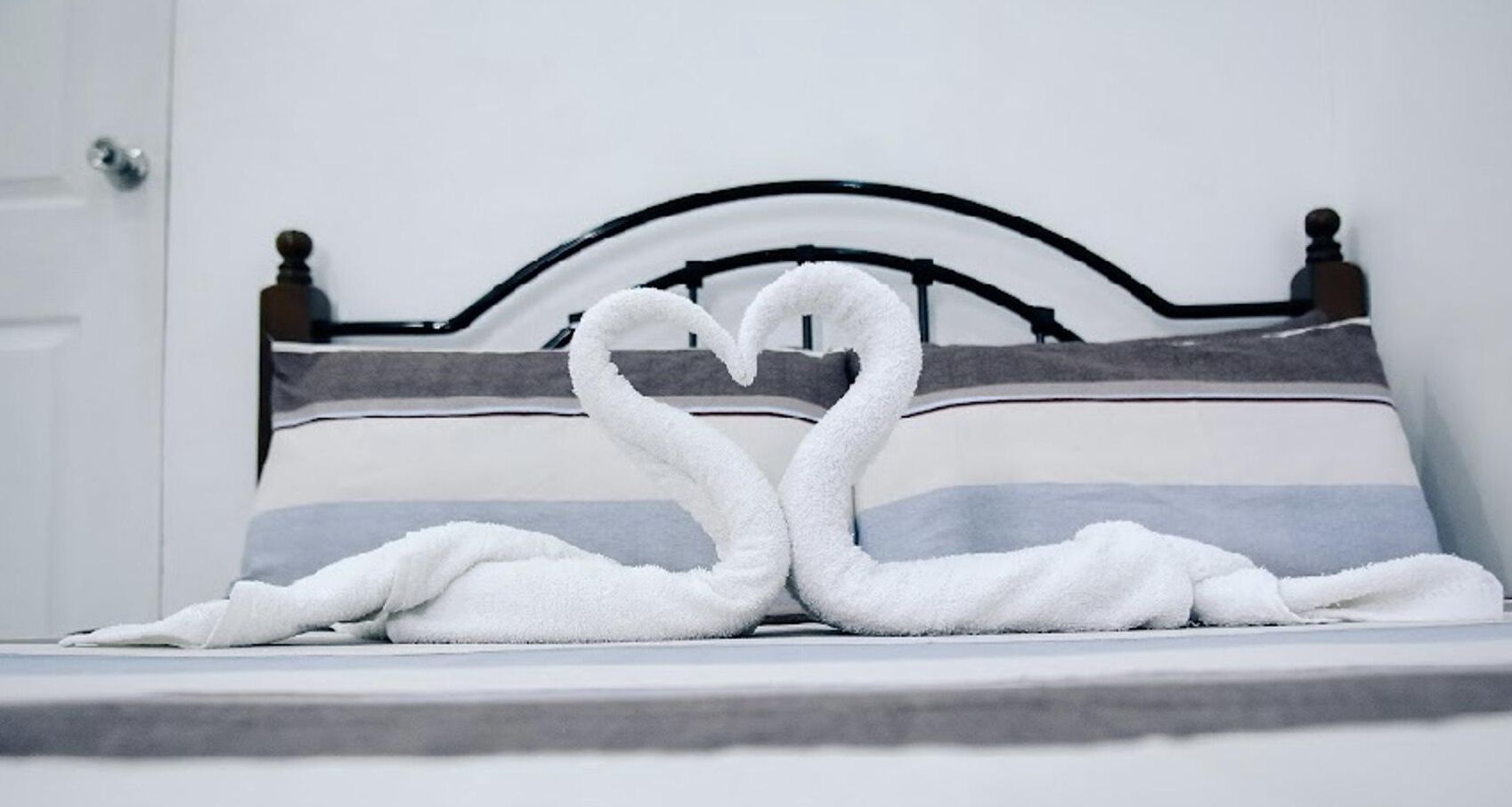 A bed with a headboard and a pillow.